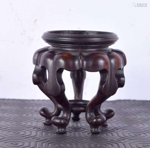 An early 20th century Chinese hardwood stand. 7.25 cm high.