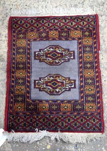 An Oriental prayer rug 65 x 21 cm