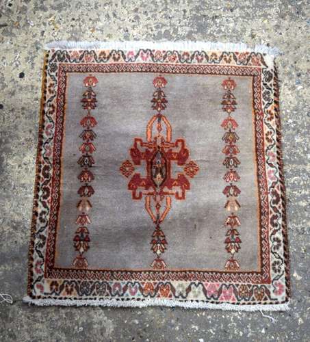 A small Oriental rug 67 x62 cm