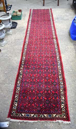 A long wool Persian runner 390 x 79 cm