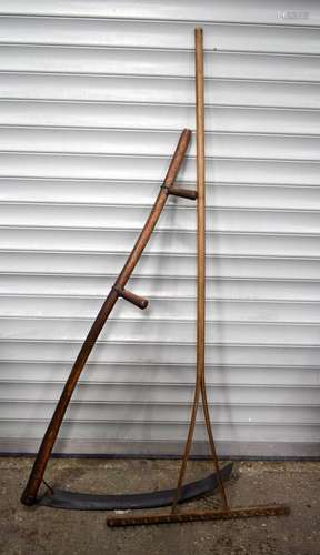 An antique Scythe together with a wooden rake largest 180 cm