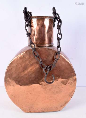 A large antique hammered copper vessel with attached chains ...