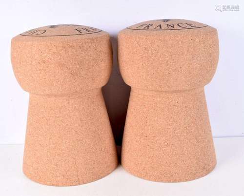 A pair of champagne cork shaped stools, cork covered tin bas...