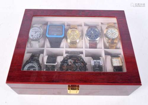 A collection of fashion watches in a display case including ...