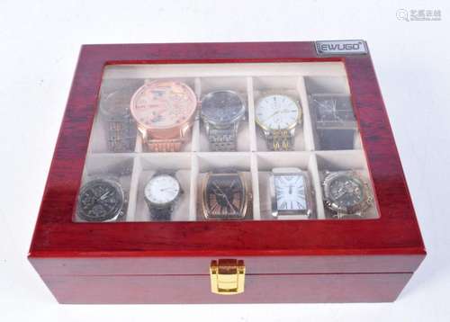 A collection of fashion watches in a display case including ...