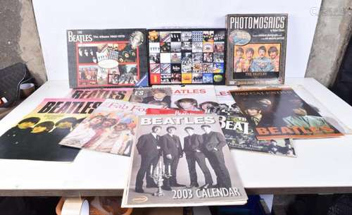 A collection of The Beatles calendars, two jigsaw puzzles an...