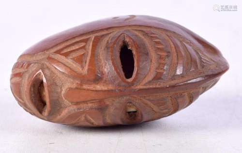 An African Tribal carved nut in the form of a ceremonial mas...