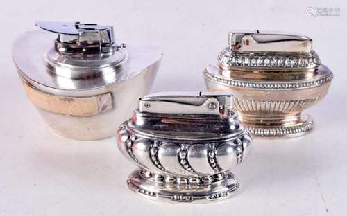 Three Ronson Table Lighters. Largest 11.1cm x 13.7cm x 7.5cm...