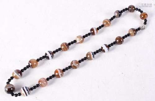 A Banded Agate Bead Necklace. 54cm long, weight 75g