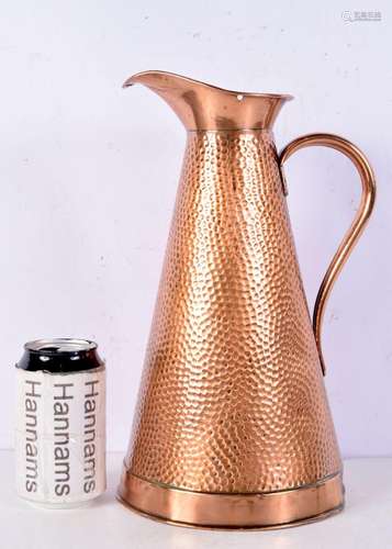 An antique hammered brass jug stamped on base 31 cm