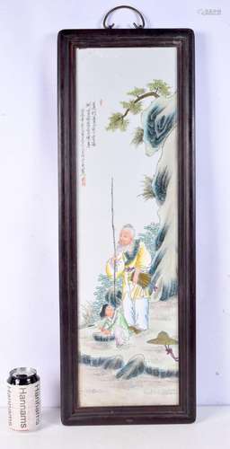 A Chinese wooden framed porcelain plaque depicting a fisherm...