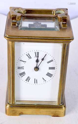 A brass carriage clock 11 x 8 cm.