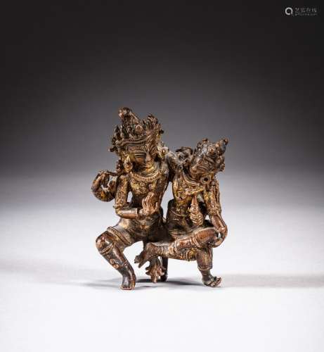 A gilt-bronze seated figure of Uma-Maheshvara, Nepal, Mala p...