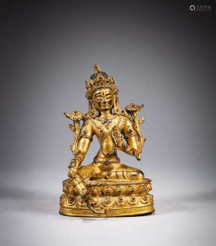 A gilt-bronze seated figure of Green Tara, Tibet, ca. 15th c...