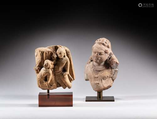 A sandstone fragmentary group depicting two Apsara and a san...