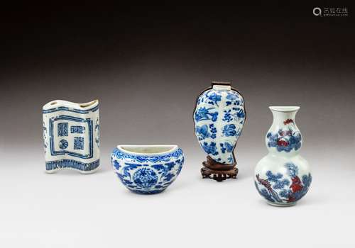 A group of three blue and white wall vases and a blue and wh...