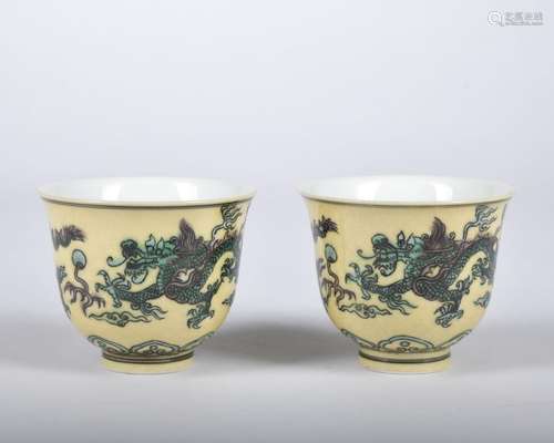 A pair of yellow ground green glazed 'dragon' cup