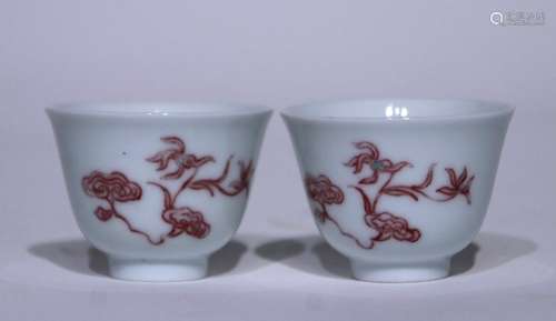 A pair of glazed red cups