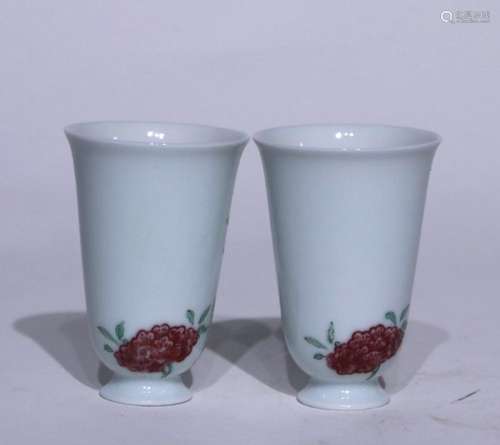 A pair of glazed red cups