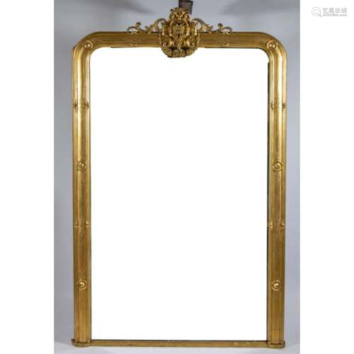 Fire-gilt wooden mirror decorated with a lion's head and...