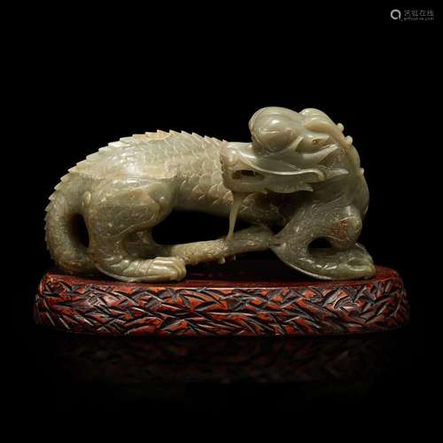 A Chinese carved celadon-grey jade dragon and wood stand 青灰...