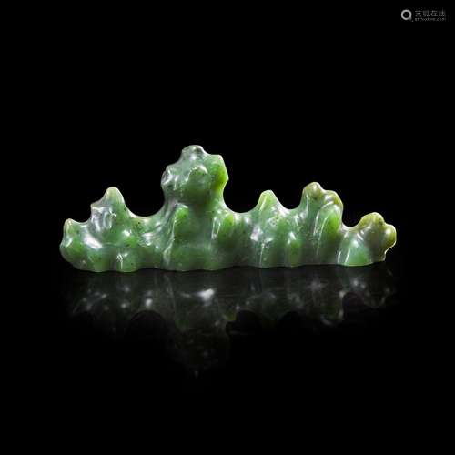 A Chinese carved spinach jade "Mountain" brush res...