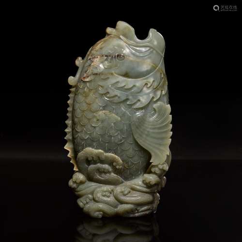 A Chinese carved celadon jade figure of a leaping carp 青玉鲤...