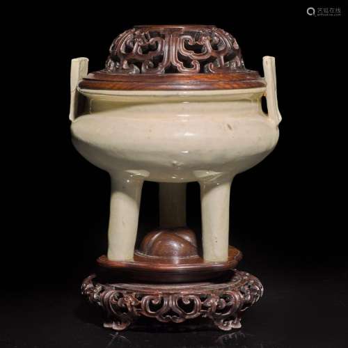 A Chinese creamy-white gazed tripod censer with finely carve...