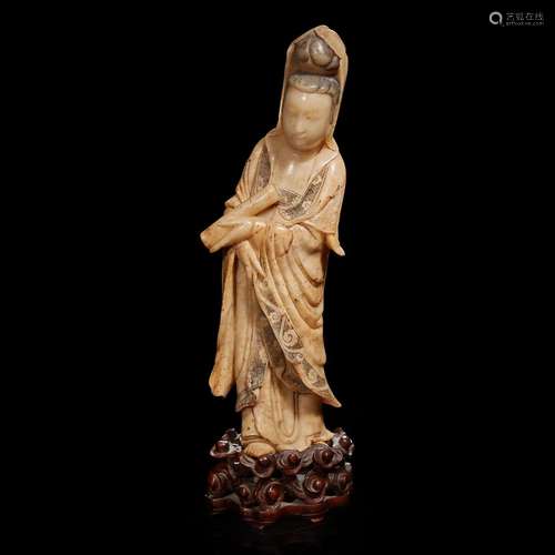 A Chinese carved beige soapstone figure of Guanyin and carve...