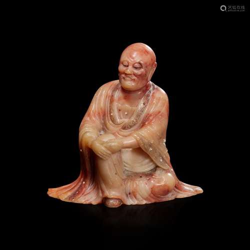 A finely-carved Chinese beige and rose soapstone figure of a...