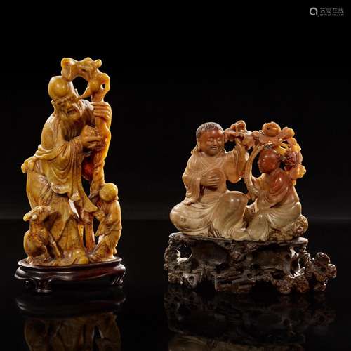 Two carved Chinese soapstone figures: Shoulao and attendant,...