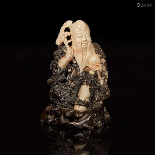 A Chinese carved beige and dark brown soapstone figure of Sh...