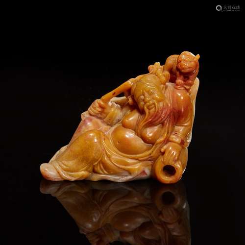 A Chinese carved amber and grey soapstone figure of Li Bai a...