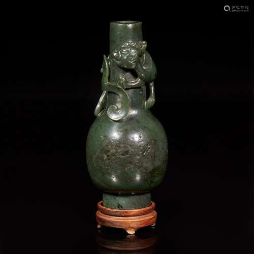 A Chinese carved spinach jade "Qilong" small bottl...