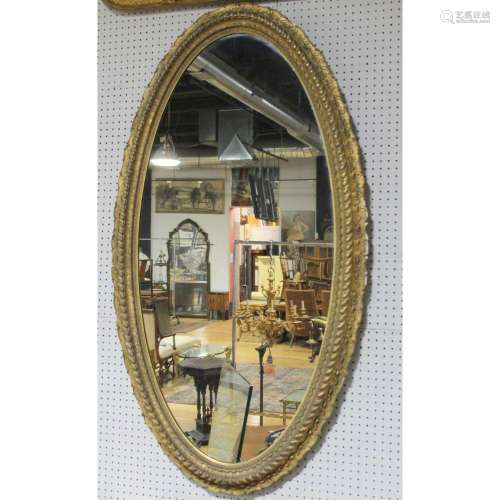 A Large Gilded Oval Victorian Mirror.