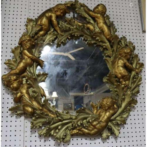 A Gilded Composition Mirror Framed With Cherubs