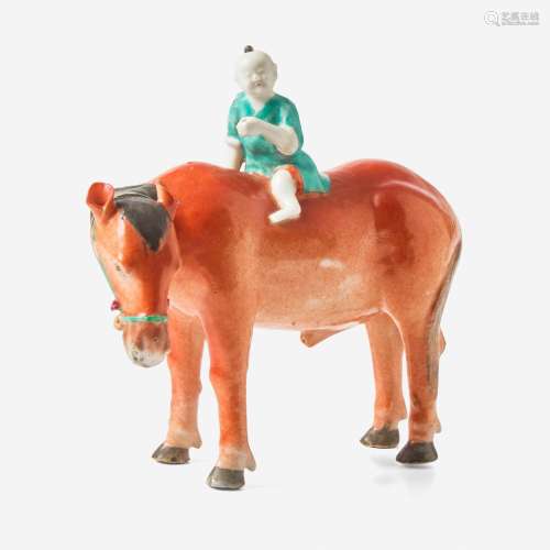 A Chinese export porcelain figure of a boy mounted on a hors...