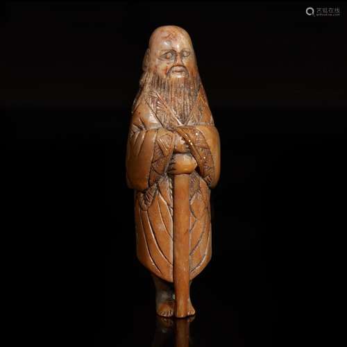 A Chinese carved brown and grey soapstone "Sennin"...