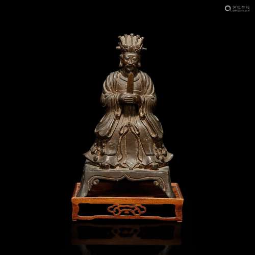 A Chinese bronze figure of a seated Daoist immortal with woo...