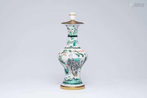 A Chinese famille verte vase with figures in a garden mounte...