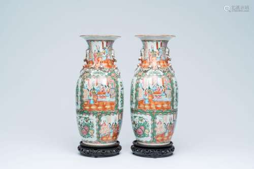 A pair of Chinese Canton famille rose vases with palace scen...