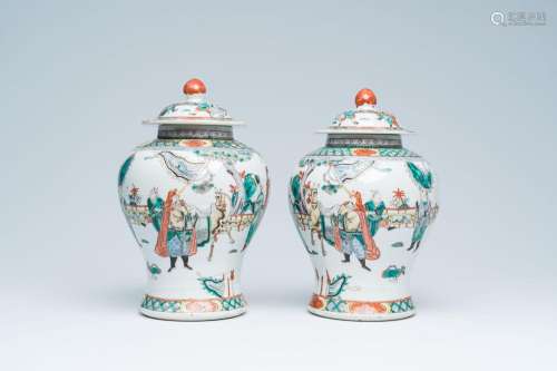 A pair of Chinese famille verte vases and covers with figure...