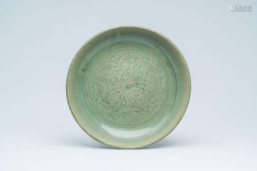 A Chinese Longquan celadon dish with underglaze floral desig...