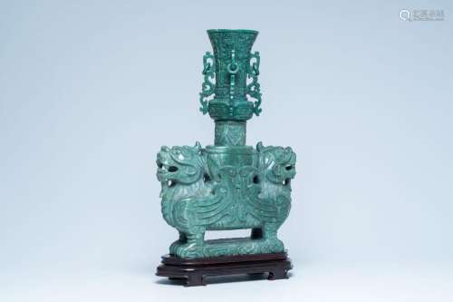 A large Chinese hardstone sculpture with a vase supported by...