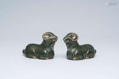 A pair of Chinese cloisonne models of rams, 20th C.<br />
H ...