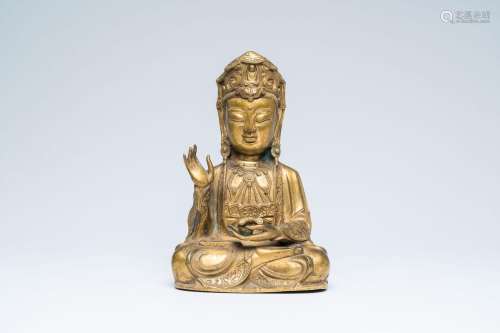 A Chinese gilt bronze figure of a seated Guanyin, 20th C.<br...