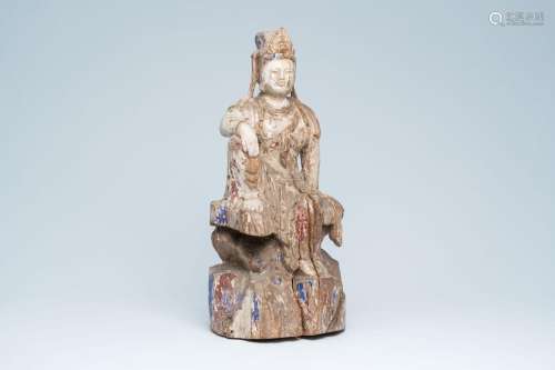 A Chinese polychromed wood sculpture of Guanyin seated on a ...