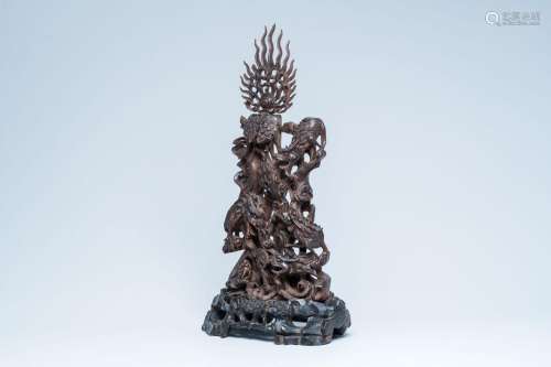 A large Chinese carved wood group of dragons chasing the fla...