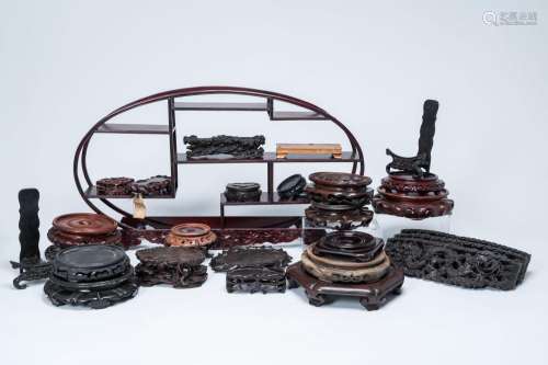 A varied collection of Chinese wood stands and an oval displ...