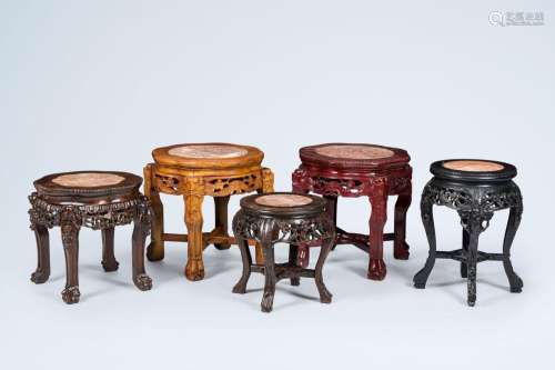 Five Chinese open worked carved wood stands with marble top,...